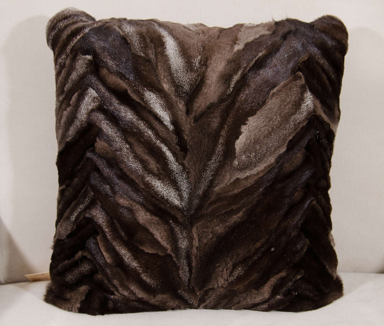 Brown silver fox pieced and sheared pillow with chocolate leather back.