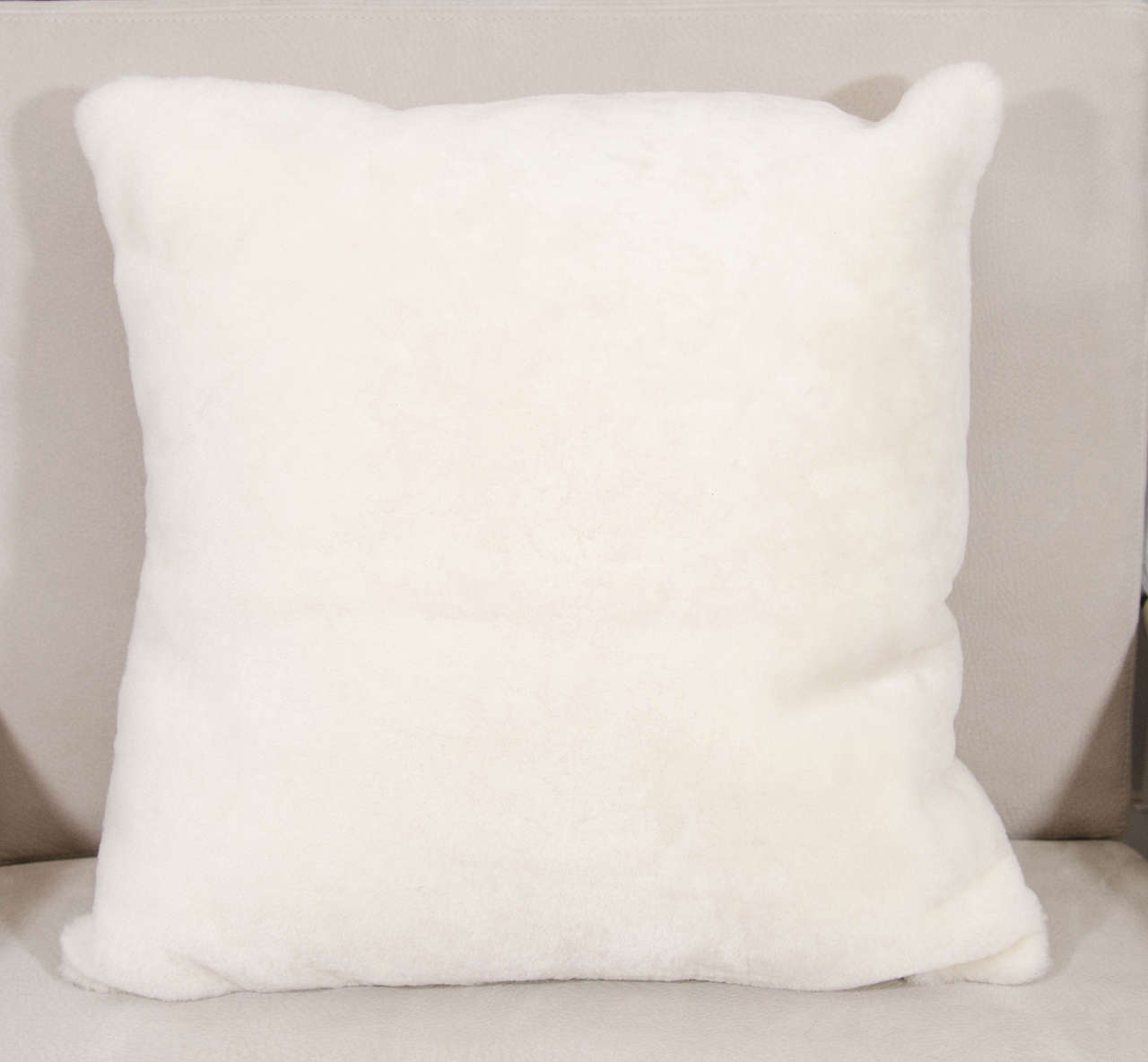 Shearling pillow with suede backing.