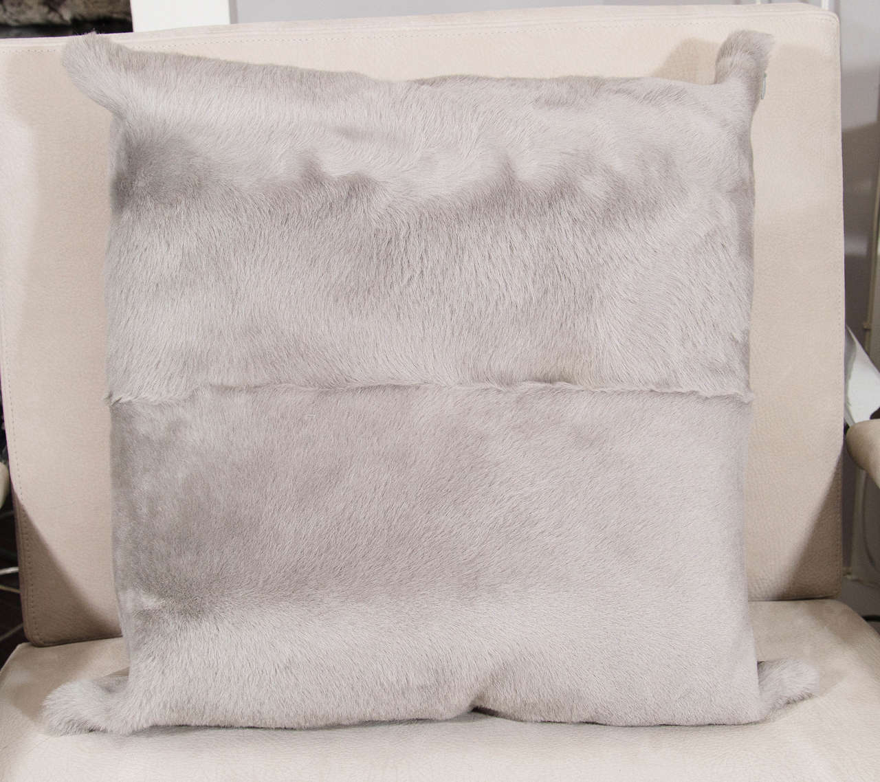 Grey sheared goat pillow with leather backing.