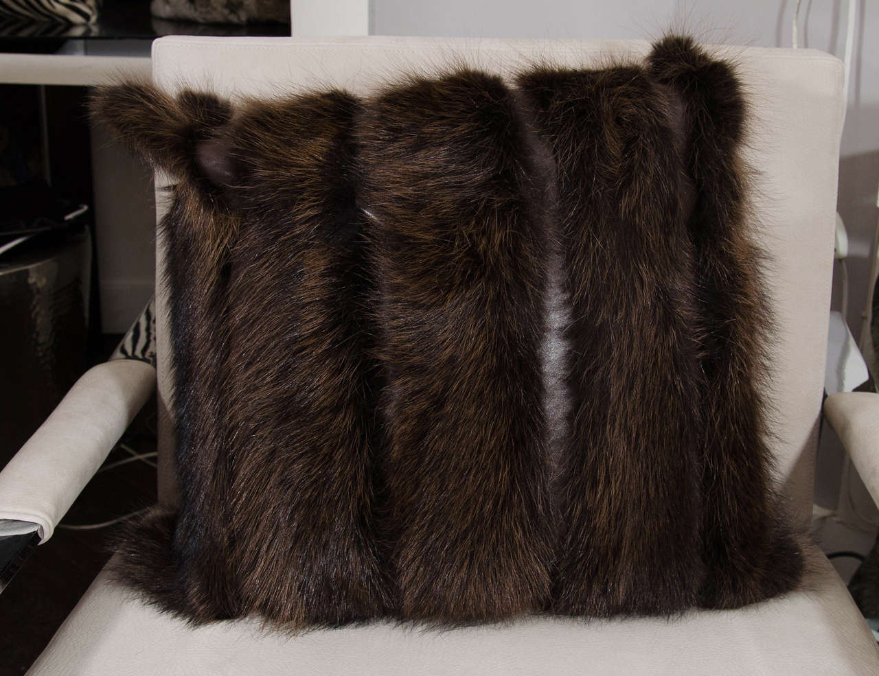 Brown fox pillow with leather stripes.