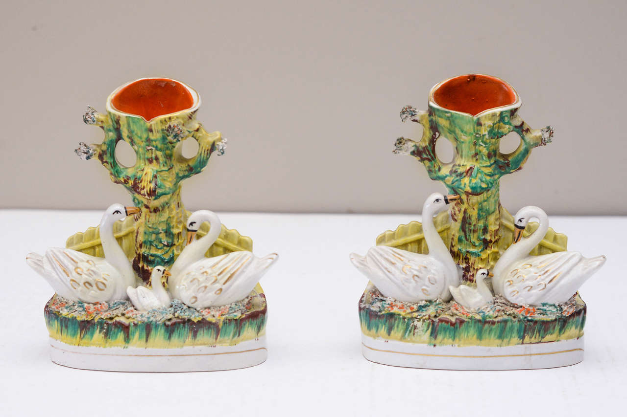 Pair of Staffordshire Swan Spill Vases, Mid-19th Century, with polychrome decoration.