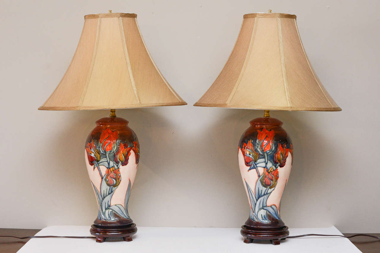 Moorcroft Tulip Pattern Ceramic Lamps, Circa 1950, mounted on Chinese hardwood bases.