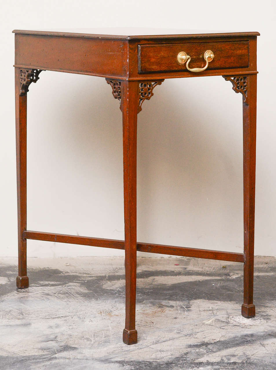 George III Style Mahogany Single Drawer Rectangular Side Table or Tea Table, Circa 1850; with quatrefoil and C-scroll carved fretwork decoration, X-from stretcher on molded block feet.