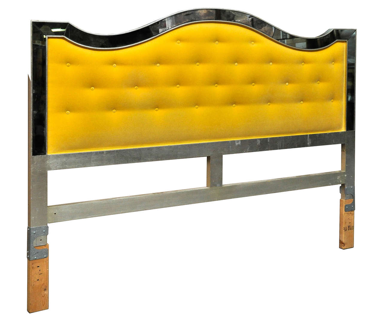 Antiqued mirror framed tufted king-size headboard reupholstered in Clarence House yellow cotton velvet.