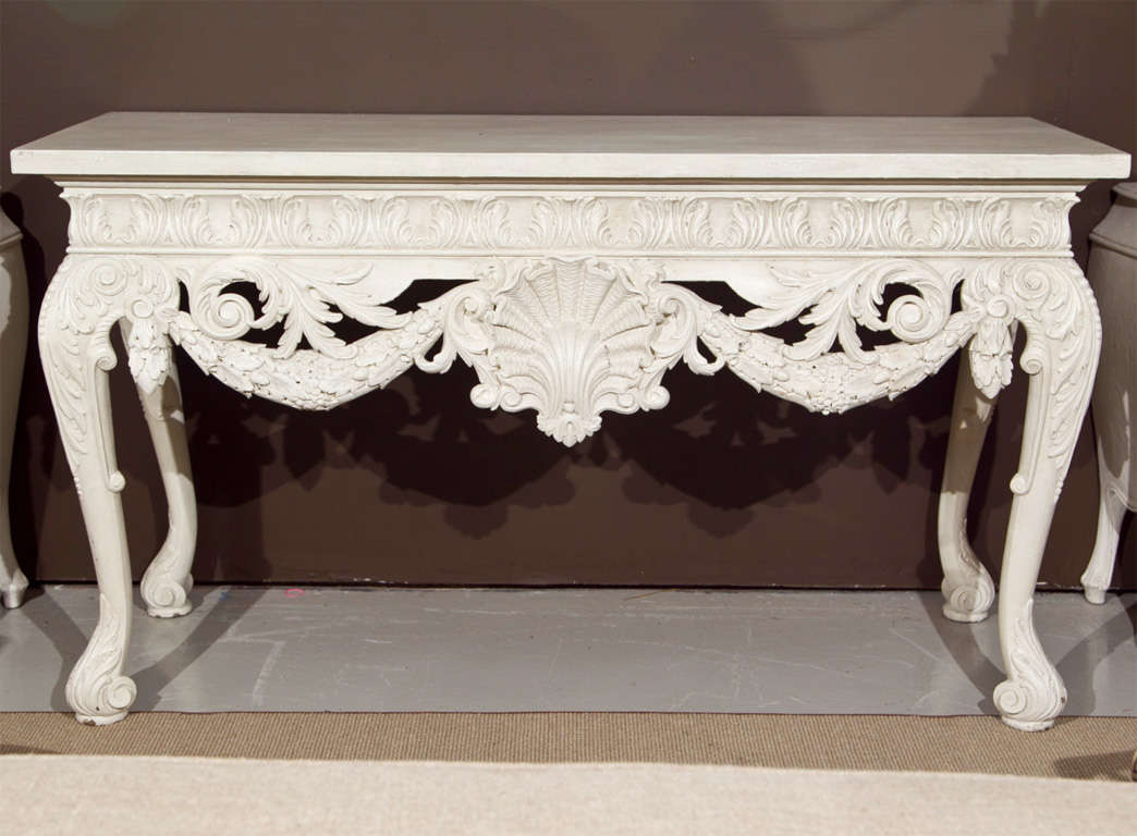 A beauty of a table... The ultimate in transitional style, this hand-carved solid wood console blends an elaborately carved detailed period console with a contemporary lacquered finish.