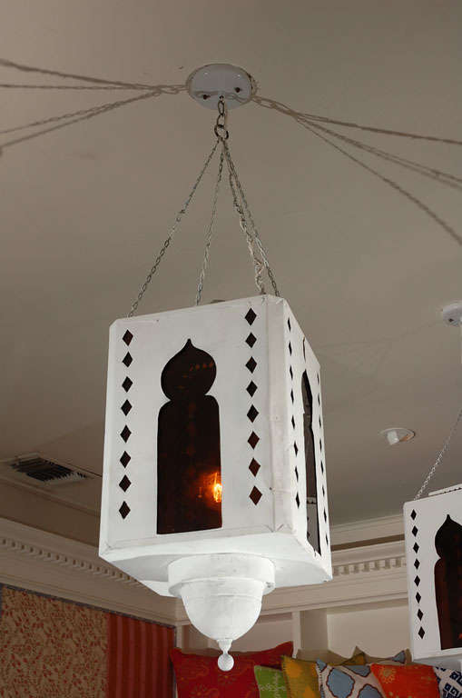 From a Hollywood Prop House, fun white painted tole lanterns with Moroccan motif and orange plexiglass. Rewired. Available singly
