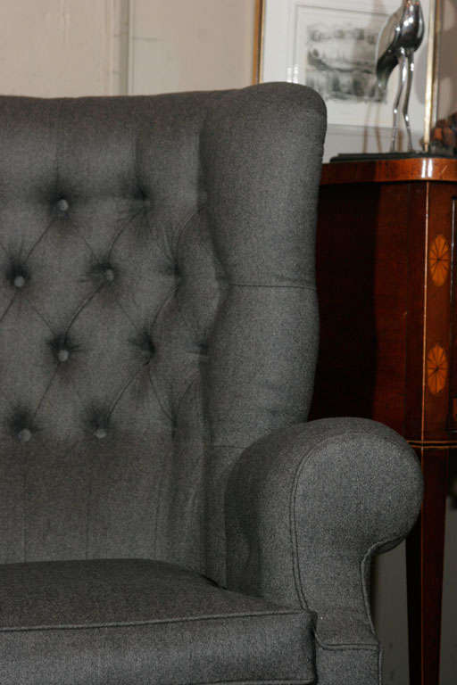 A pair of large wing back armchairs Circa 1920's
