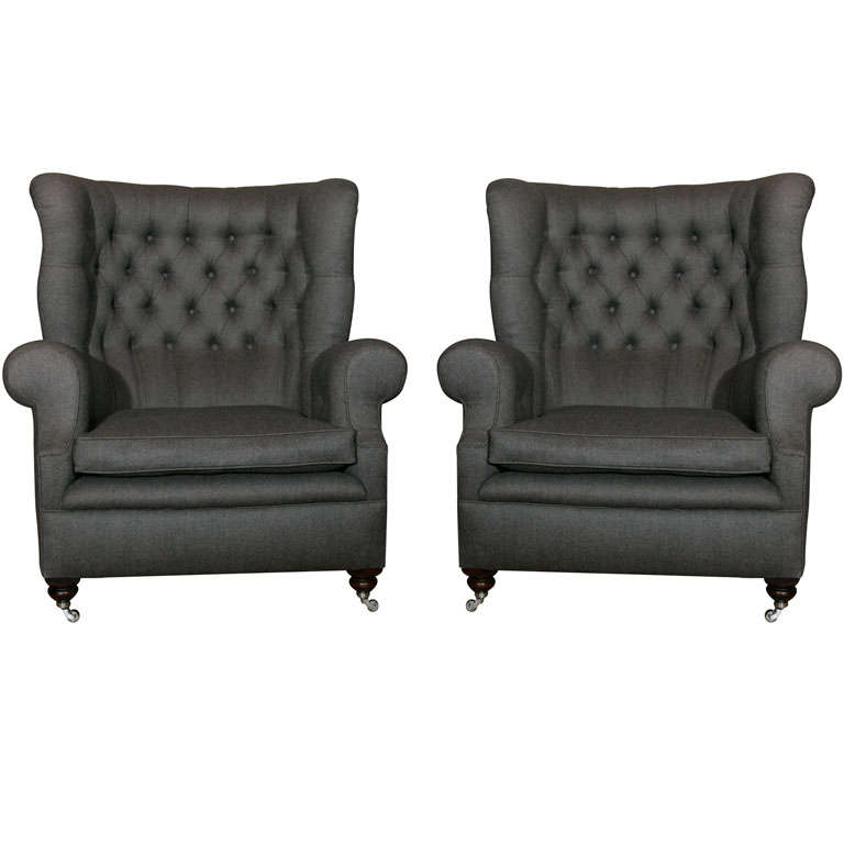A pair of large wing back armchairs For Sale