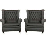 A pair of large wing back armchairs