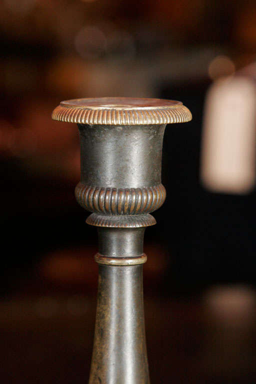 Bronze A pair of Regency bronze candlesticks For Sale