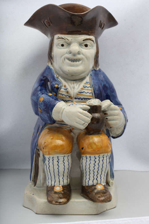 A fine English pearlware toby jug decorated in underglaze Pratt colors