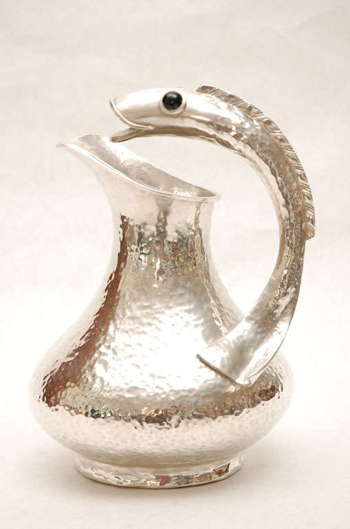 This great piece of Mexican artistry truly shows the craftsmanship of Los Castillos silver smiths. Pitcher features a very unique handle of an intricately detailed fish with onyx eyes. Piece is stamped and marked on the underside. View image 10.