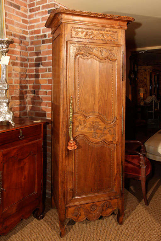 Small French Oak Bonnetiere

This is a small French bonnetiere from the Louis XVI period. It is a nice sweet size because it is very narrow.

It has the original bonnet on top and the door is beautifully carved with raised panel work.  

It is