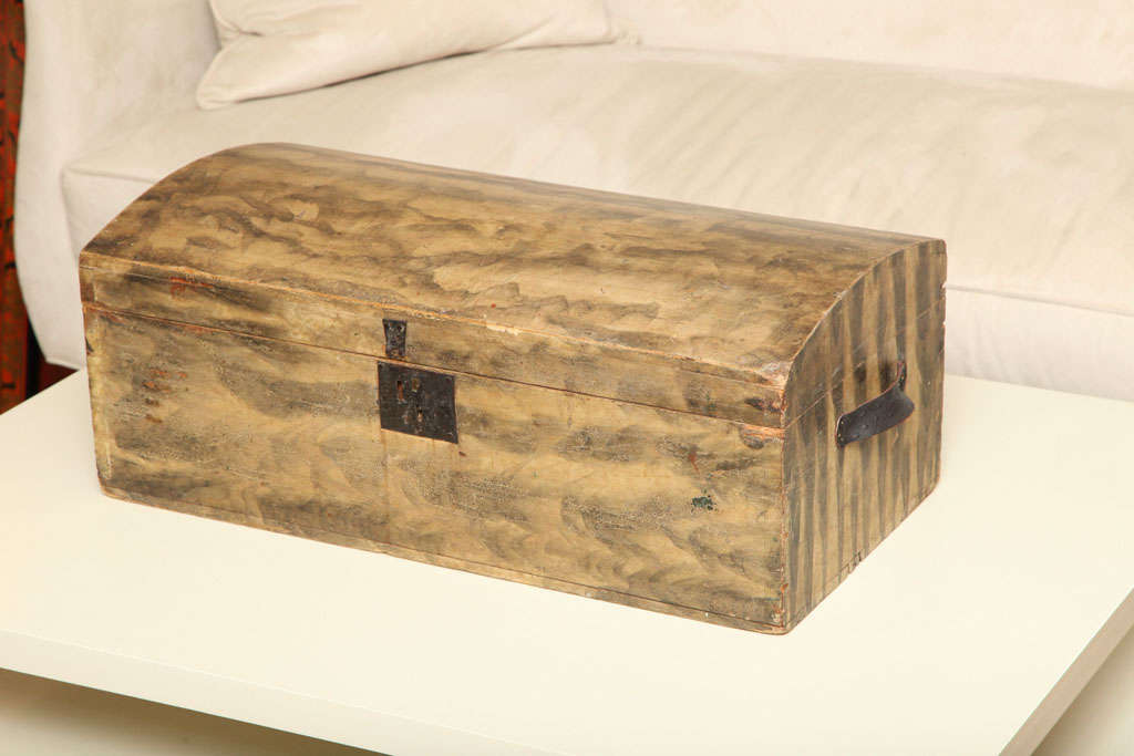 One decorative storage box with hand applied faux finish and original leather handles.