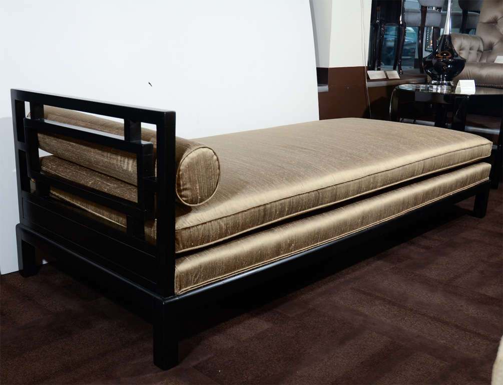 Beautiful day bed with matte black<br />
lacquer finish and upholstered in<br />
a bronze silk Dupioni fabric.<br />
The bed is designed with one open<br />
side and has stylized side frame<br />
with modern squares cut-out <br />
design.