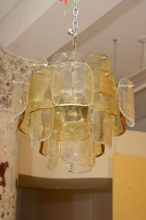 Bold Camer chandelier with Mazzega art glass elements. The art glass pieces are both clear and amber. The Camer company was inspired by the classic clay roof tiles of Mediterranean villages when they designed this series. Please contact for location.