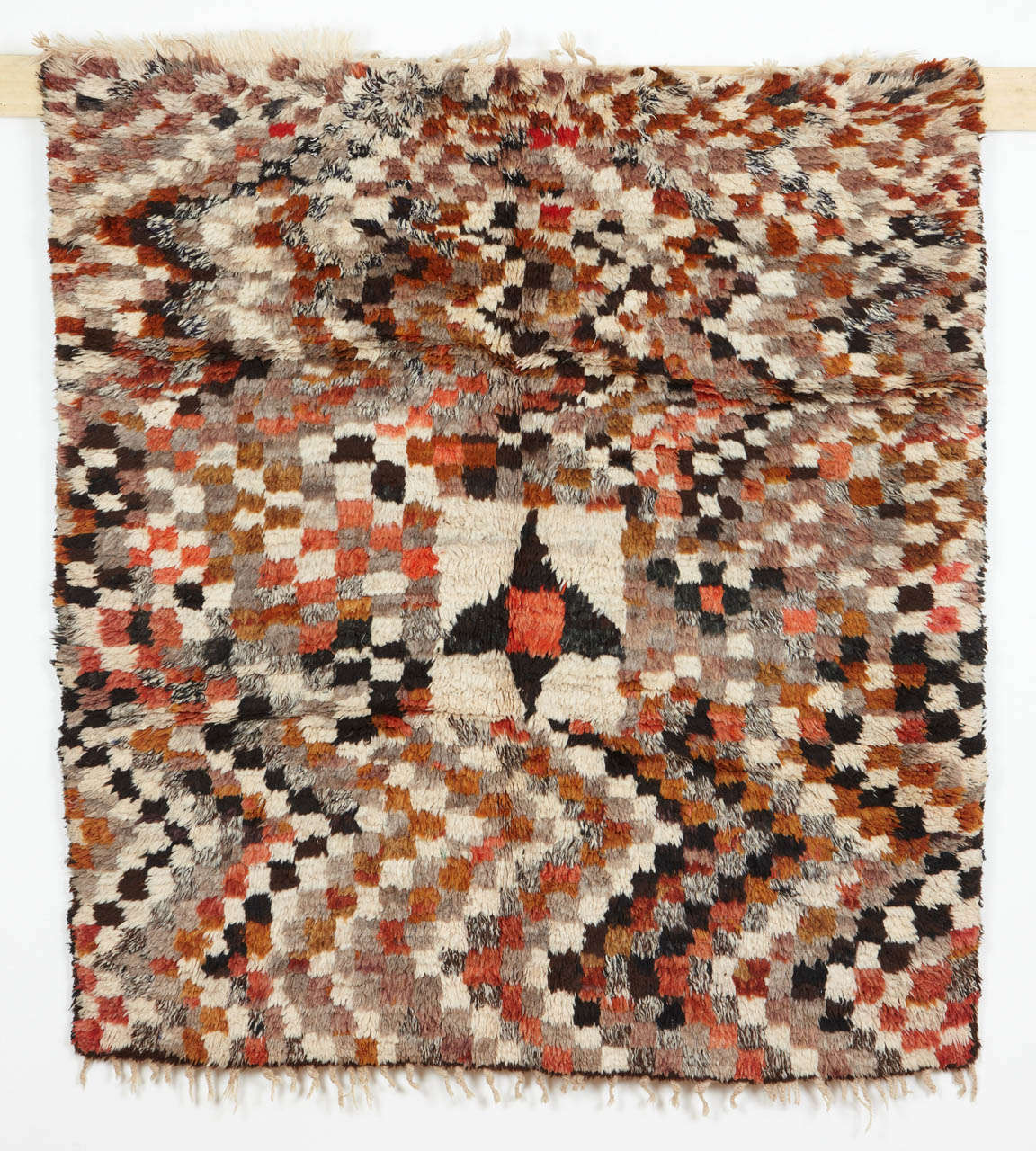A group of rugs from the Azilal region, located in the central High Atlas, are distinguished by funky renditions of Moroccan carpet designs. This thick piled example displays an abstract variation on the checkerboard pattern.