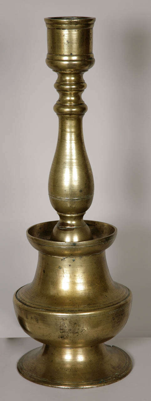 Cast and turned in two separate sections with a flaring base and three bulbous sections.
