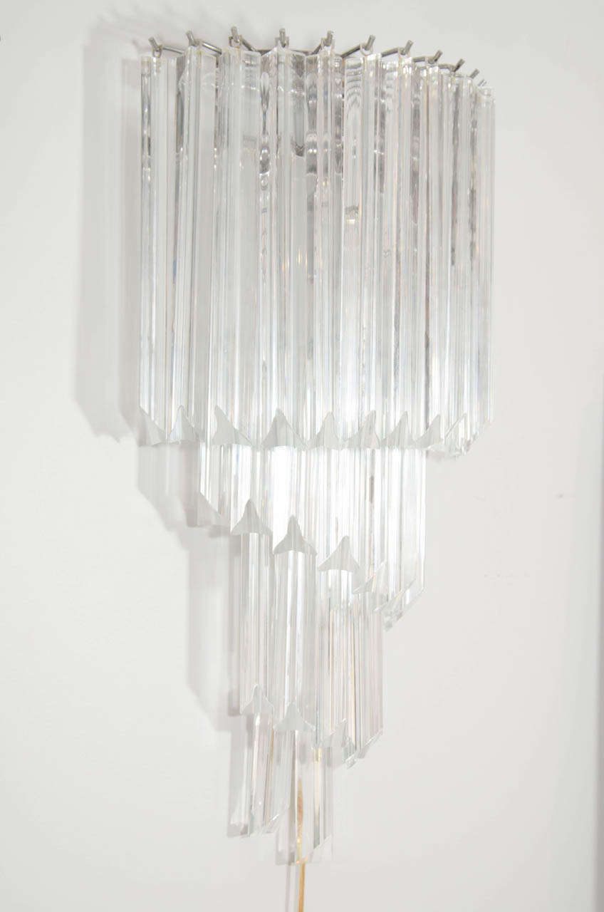 A sparkling pair of cascading Venini sconces consisting of four tiers of triangular (triedri) clear glass crystals on a metal frame.