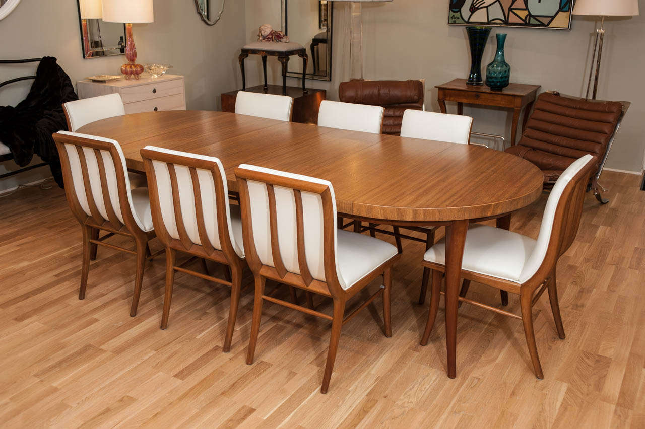 A rare and refined oval dining table with four 14