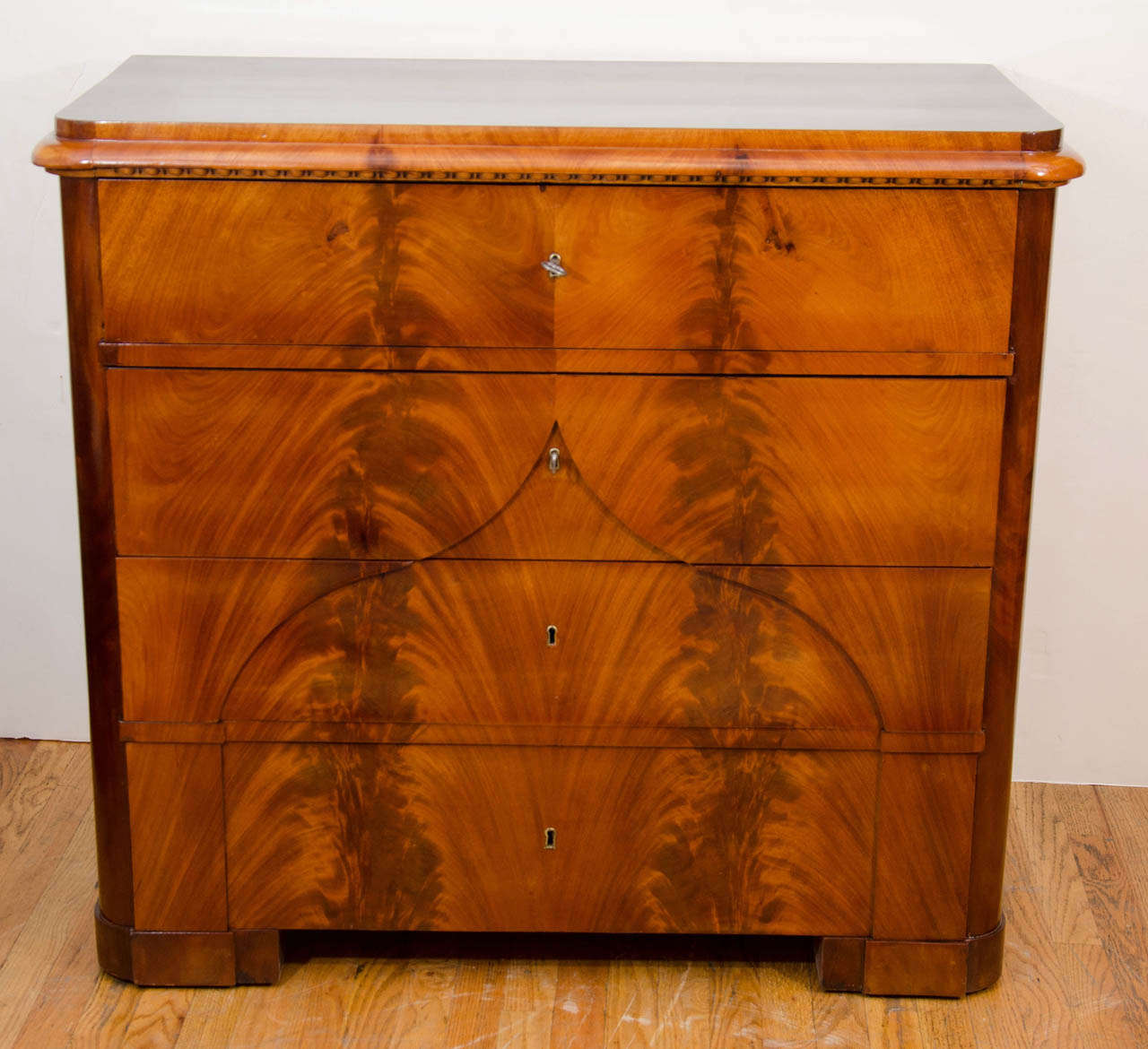 A locking, four drawer chest, whose uppermost drawer drops to reveal six interior drawers and a double-doored inner cabinet designed for safeguarding valuable documents or jewelry.  Crafted of solid fir, birch and mahogany, and embellished with
