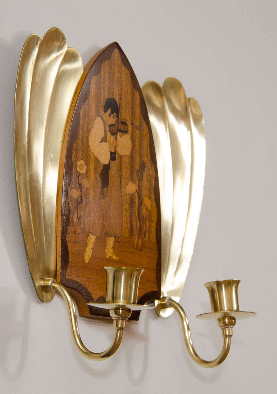 A whimsical pair of sconces created for candlelight. Always intrigued by the good life; in southern Europe, the Swedes liked portraying happy musicians in costume. The theme of the dancing and playing musicians was often invoked in furnishings for