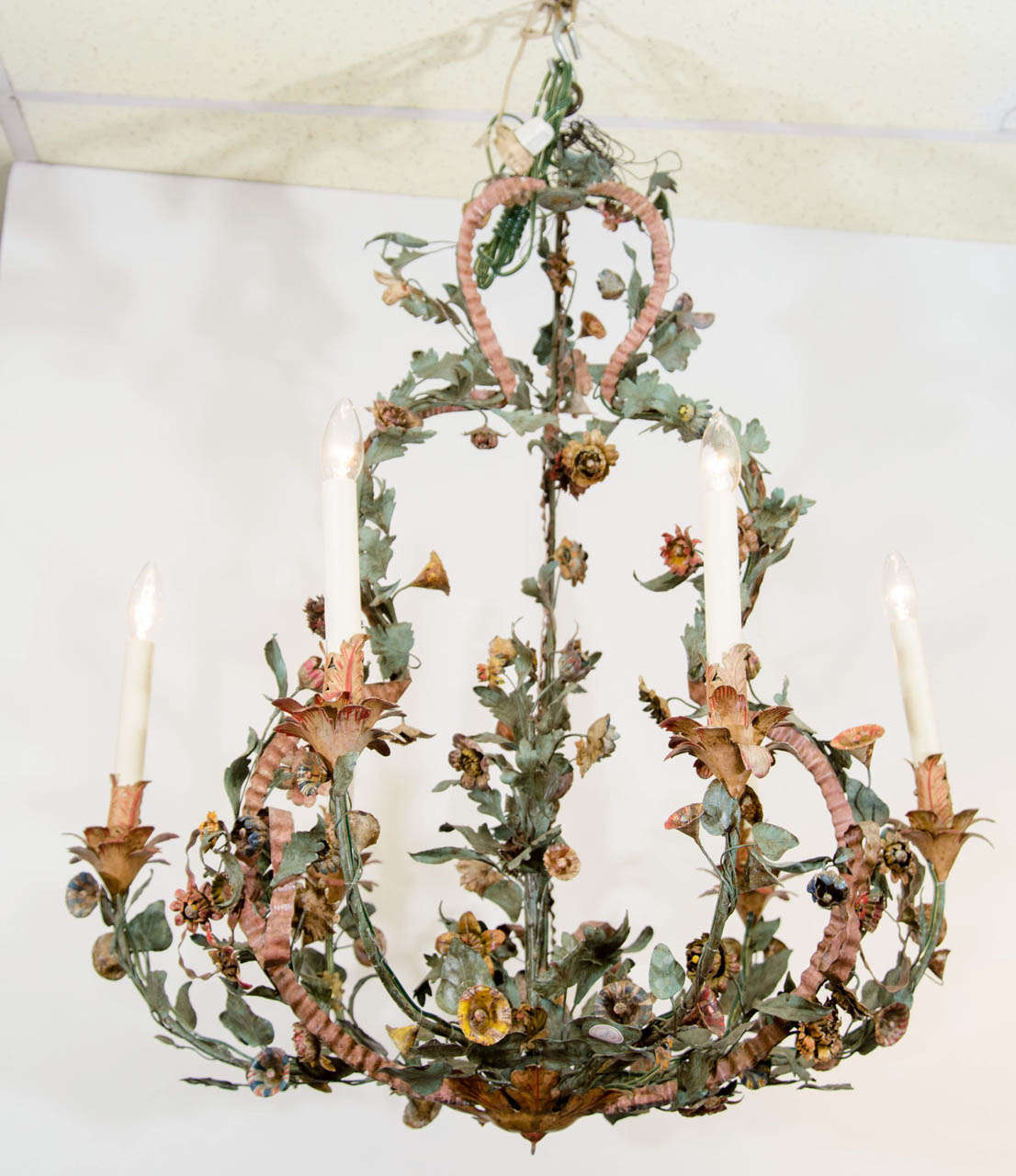 French Louis XV tole peinte six light chandelier with flowers and ribbon motif.