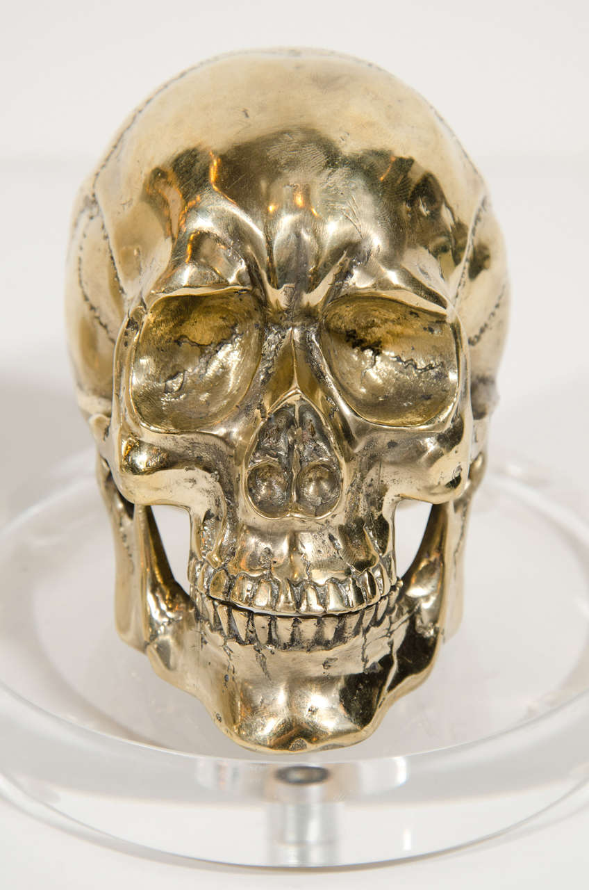 Hand-forged Gothic sculpted skull in brass metal with custom Lucite base.