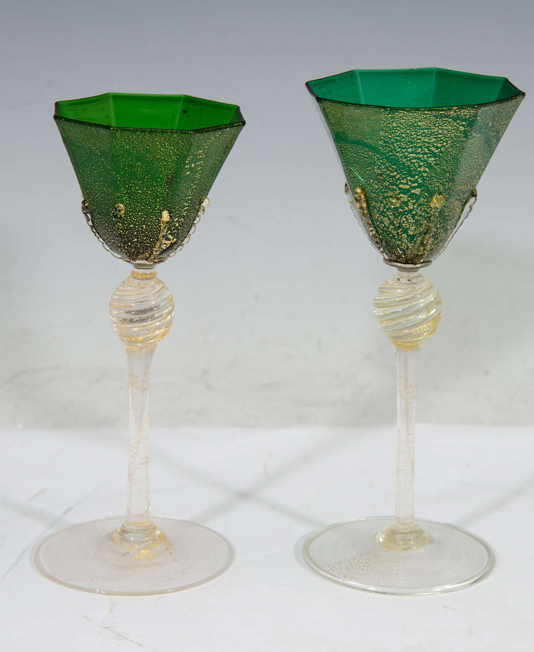 A vintage set of eight large and four smaller emerald-green with gold fleck Venetian glass stemware.

Large glasses: 7.75