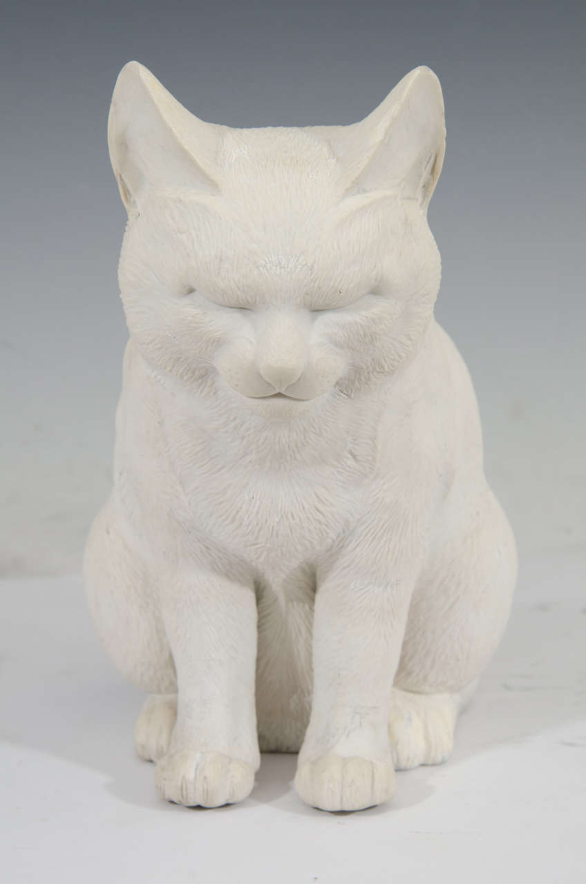 A Hirado bisque porcelain sculpture of a sitting cat with its eyes closed. This is a rare and beautiful example of one of the most famous of Hirado porcelain productions; the sitting sleeping cat. Modeled in unglazed, bisque porcelain with great