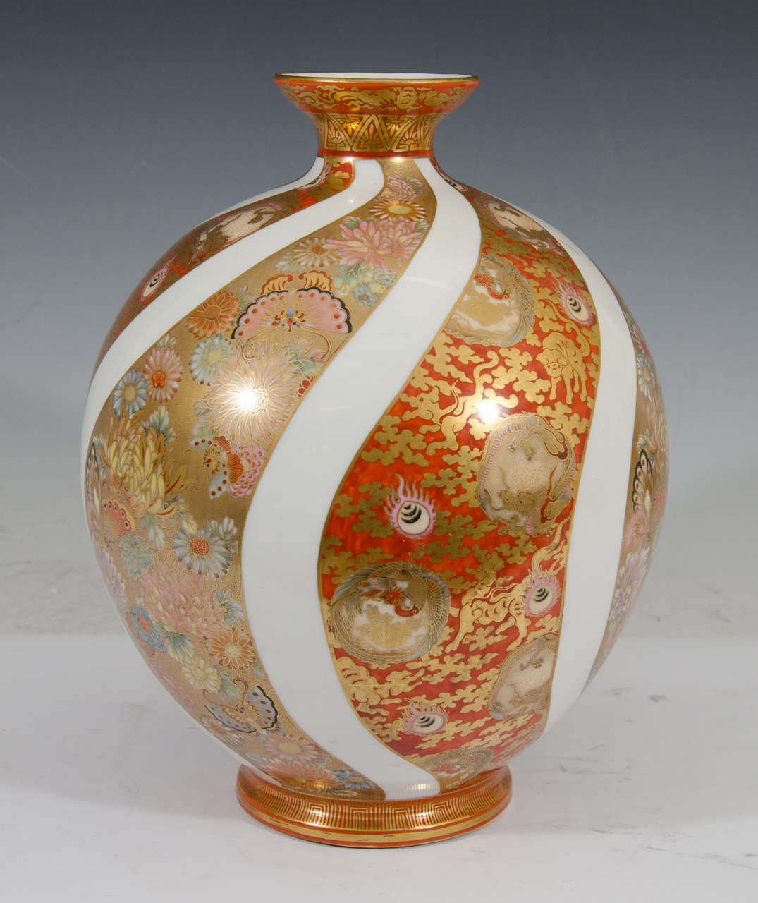 A Japanese Kutani vase with thick white stripes and floral design, circa 1900. Marked on the bottom.

Good vintage condition with age appropriate wear.