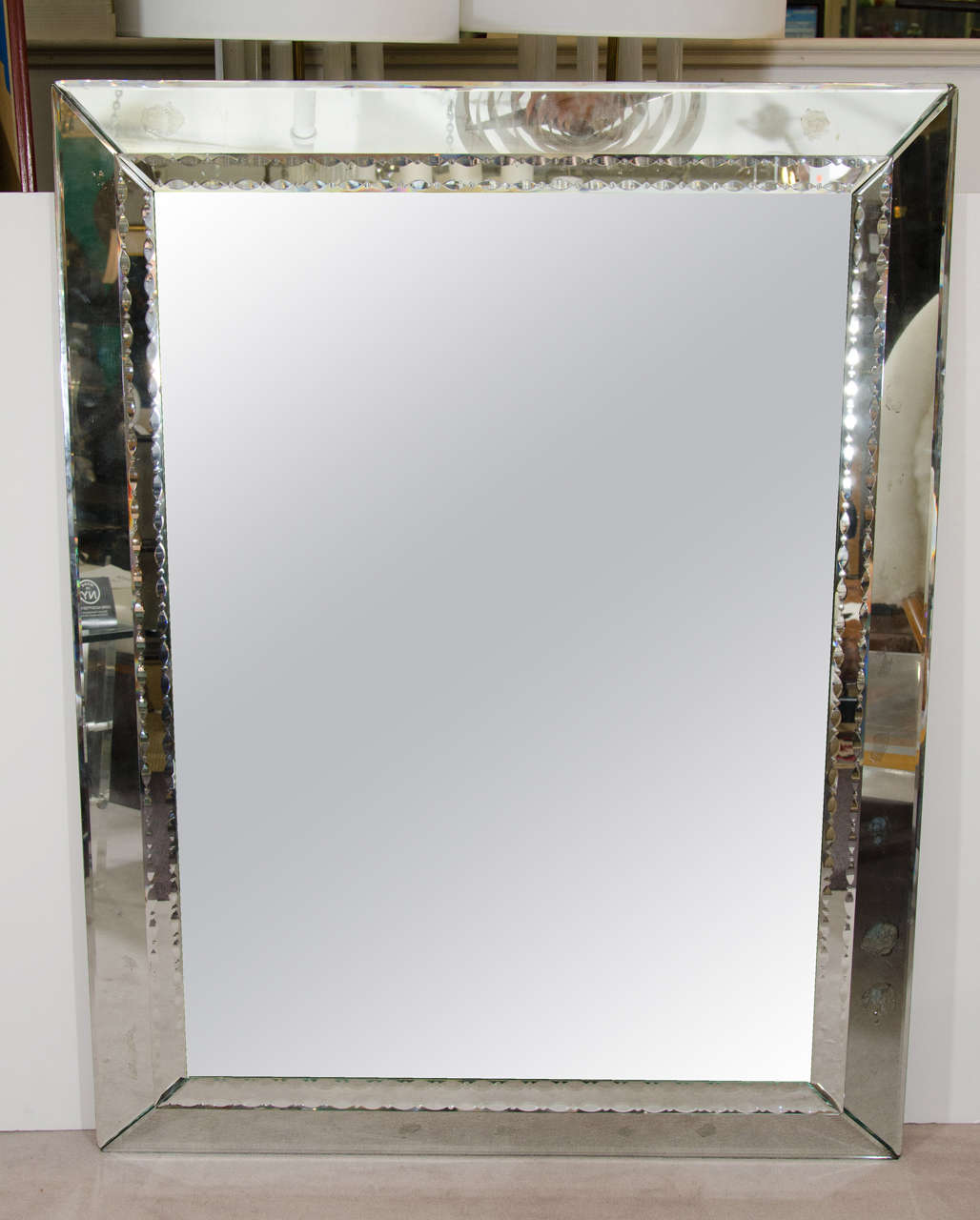 A large Italian Venetian wall-mounted mirror with beveled outer frame and an etched egg and dart pattern around the inner frame, circa 1960s.

Good vintage condition with age appropriate wear. Some silvering.