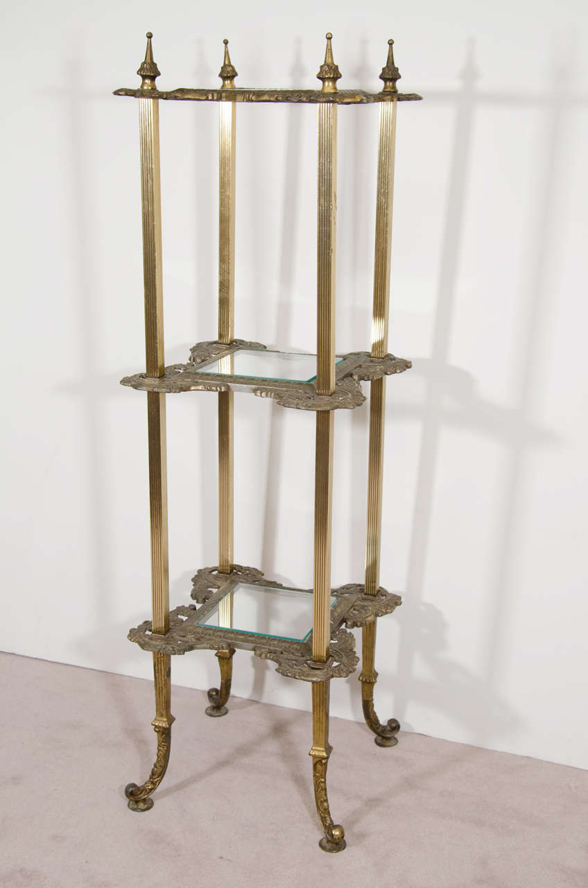 A 19th century three-shelf brass, metal and glass plant stand or pedestal.

Good vintage condition with age appropriate patina.

Reduced from: $950