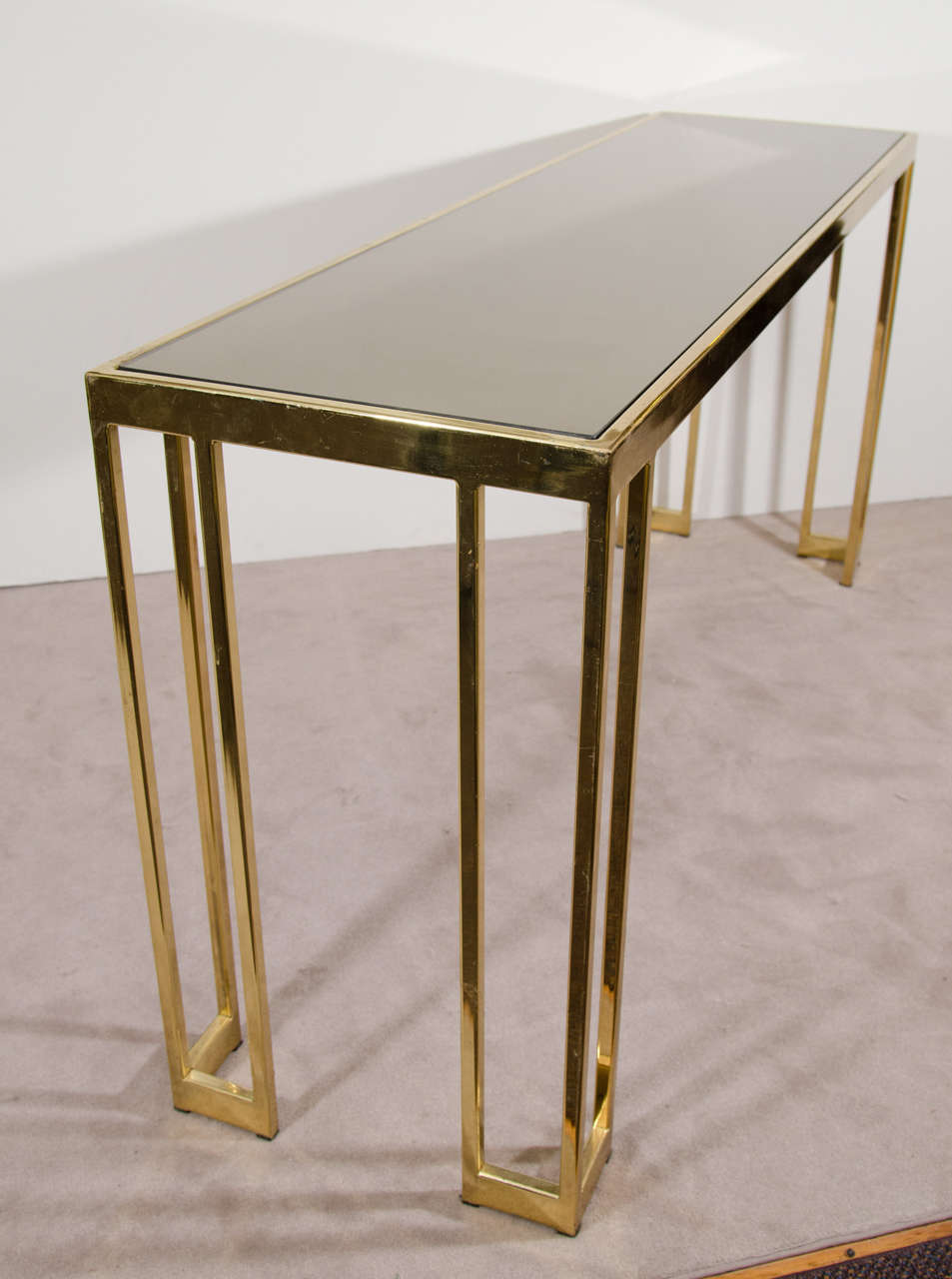 A vintage console in brass with bronze mirrored top by James Howell Tri Mark.

Good vintage condition with age appropriate patina. Some wear.