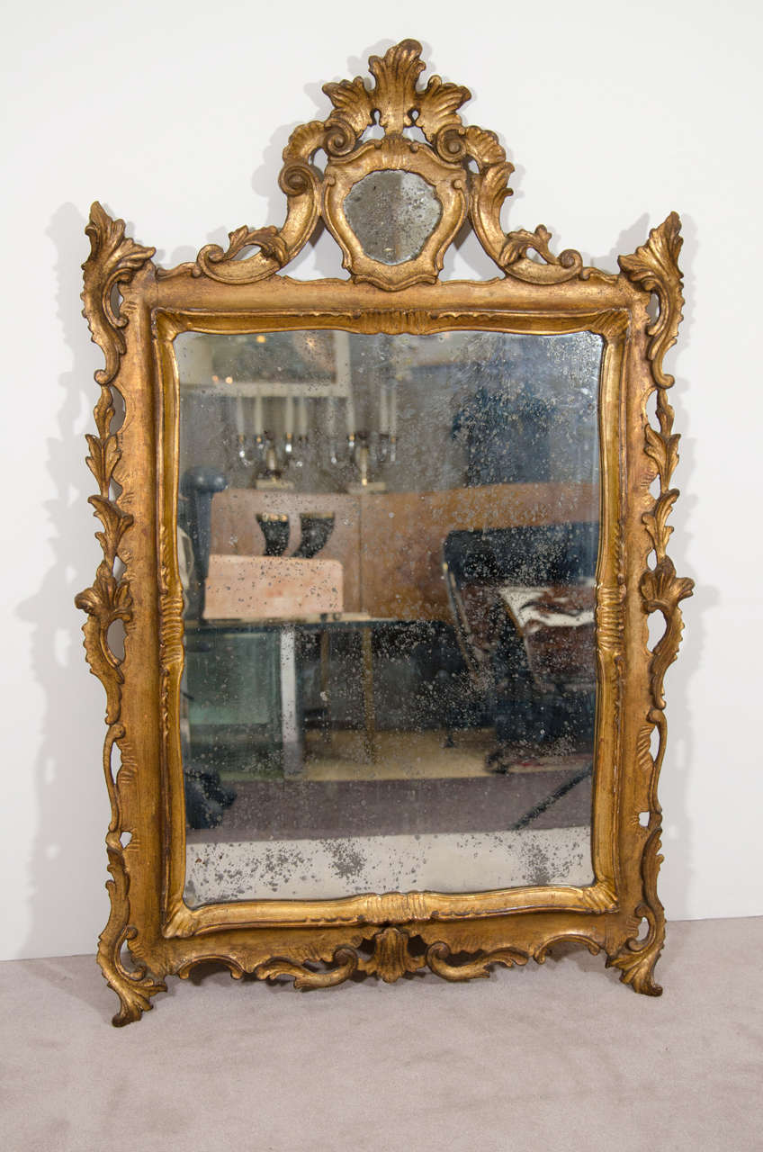 A stunning giltwood Italian wall mirror, circa 1920s. Retains original paper label 