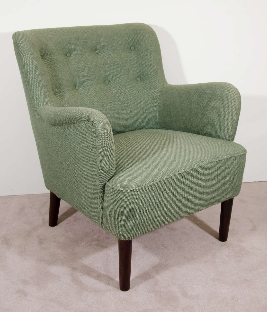 A Scandinavian pair of easy chairs or armchairs in button tufted green wool upholstery.