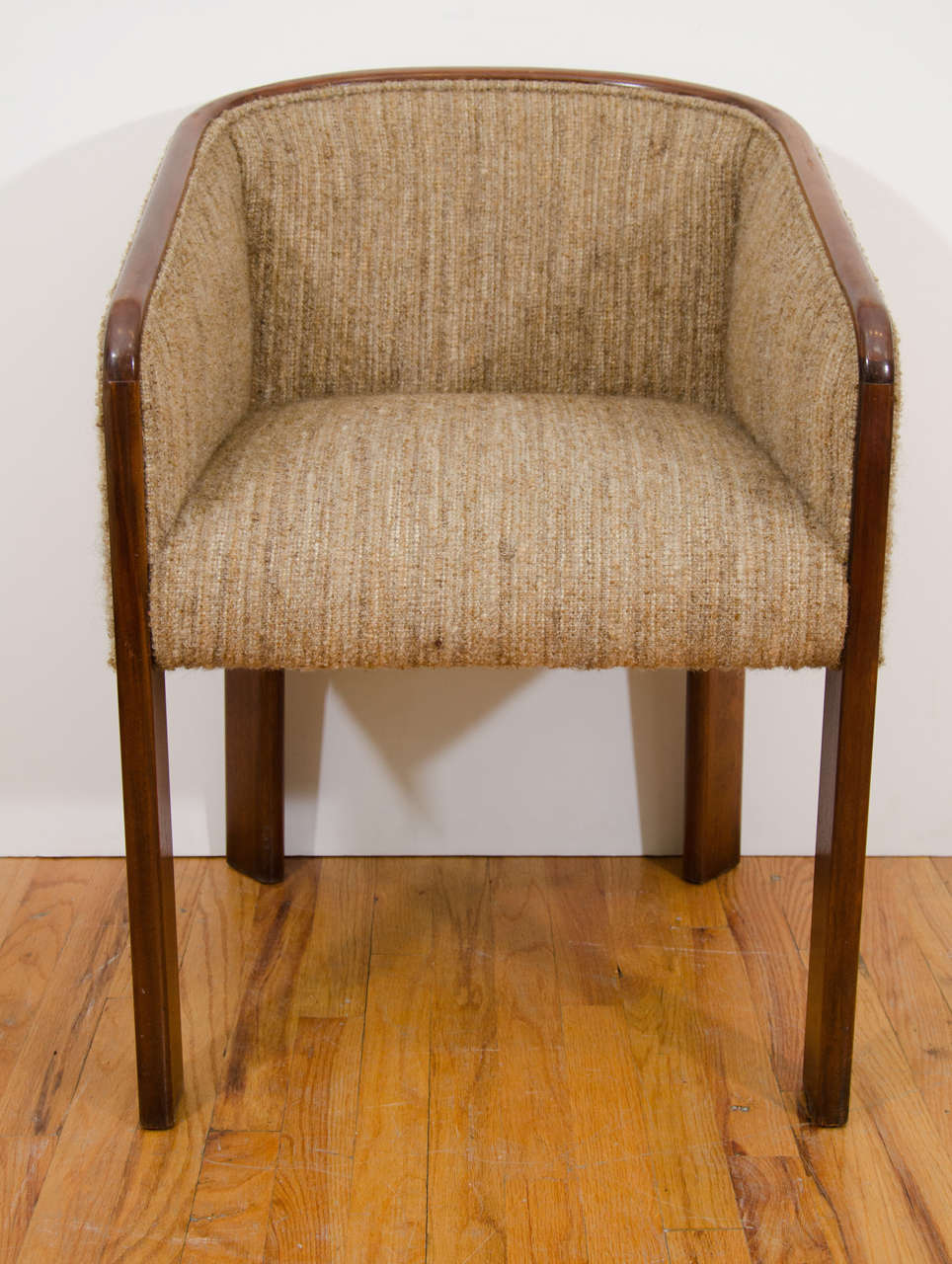 A pair of vintage tub armchairs, produced circa 1970s by Baker Furniture, upholstered in nubby wool against a wood frame. Markings include the original label [Baker Furniture] on the bottom. Very good condition, wear consistent with age and use,