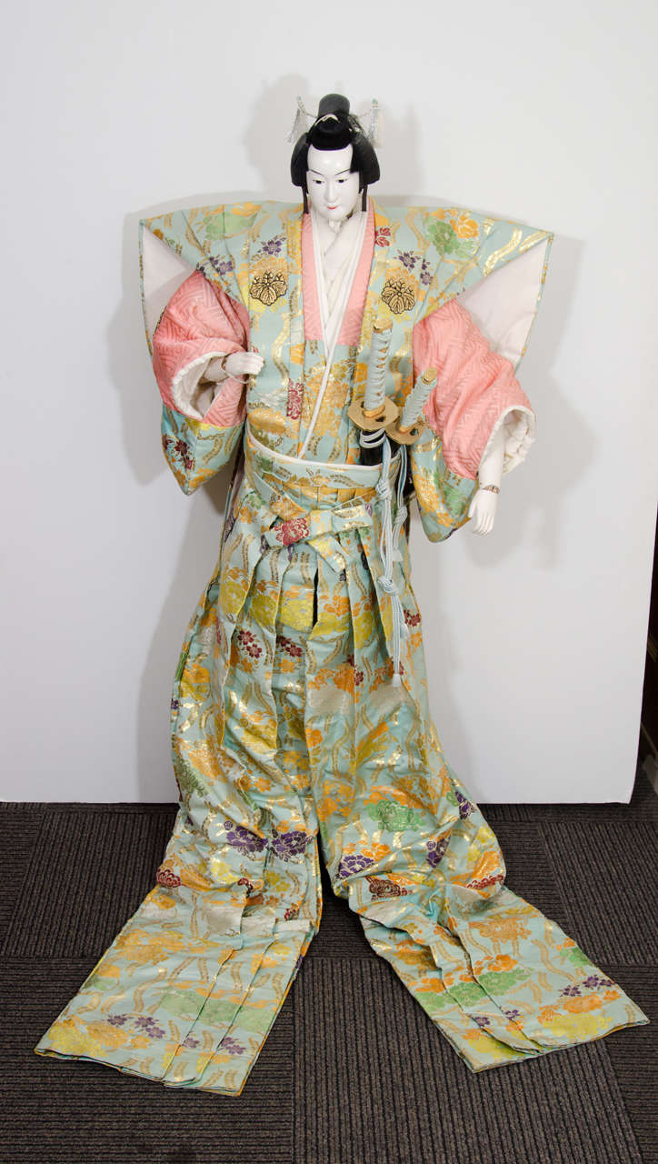 A large Japanese puppet. This puppet was used as the hero in the play "Honcho Niju Shiko Jushu Konodan." The puppet has painted features and is made of wood and covered with many layers of gofun (crushed oyster shell). His head moves up