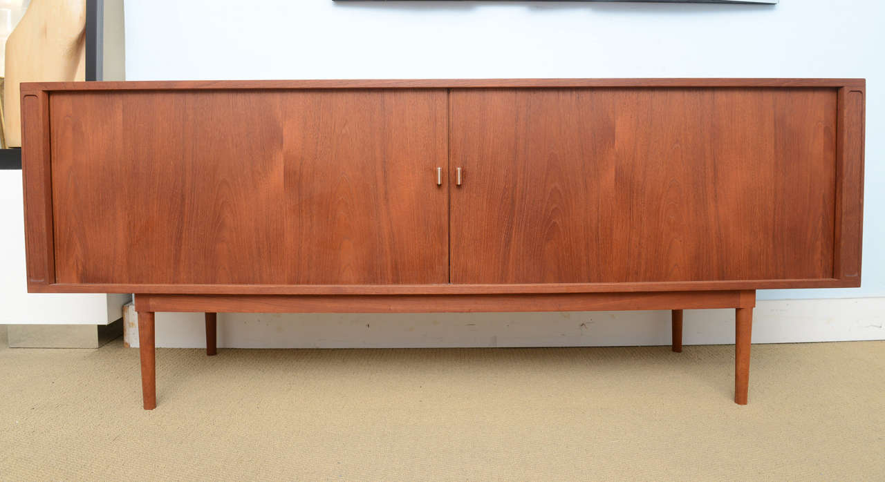 A beautiful example of Danish Mid-Century Modern sideboard, cabinet, credenza designed by Peter Løvig Nielsen in the 1960s. The center houses a column of drawers and to each side shelving. The piece is in excellent vintage condition and would be an