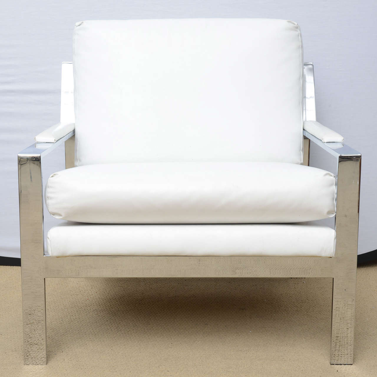 Very cool white modern Cy Mann  chairs dating from the 1970s. These are upholstered in a white Naugahyde, chrome is in very good condition. If the white Naugahyde does not work for you and provide us with the fabric of your choice we will gladly