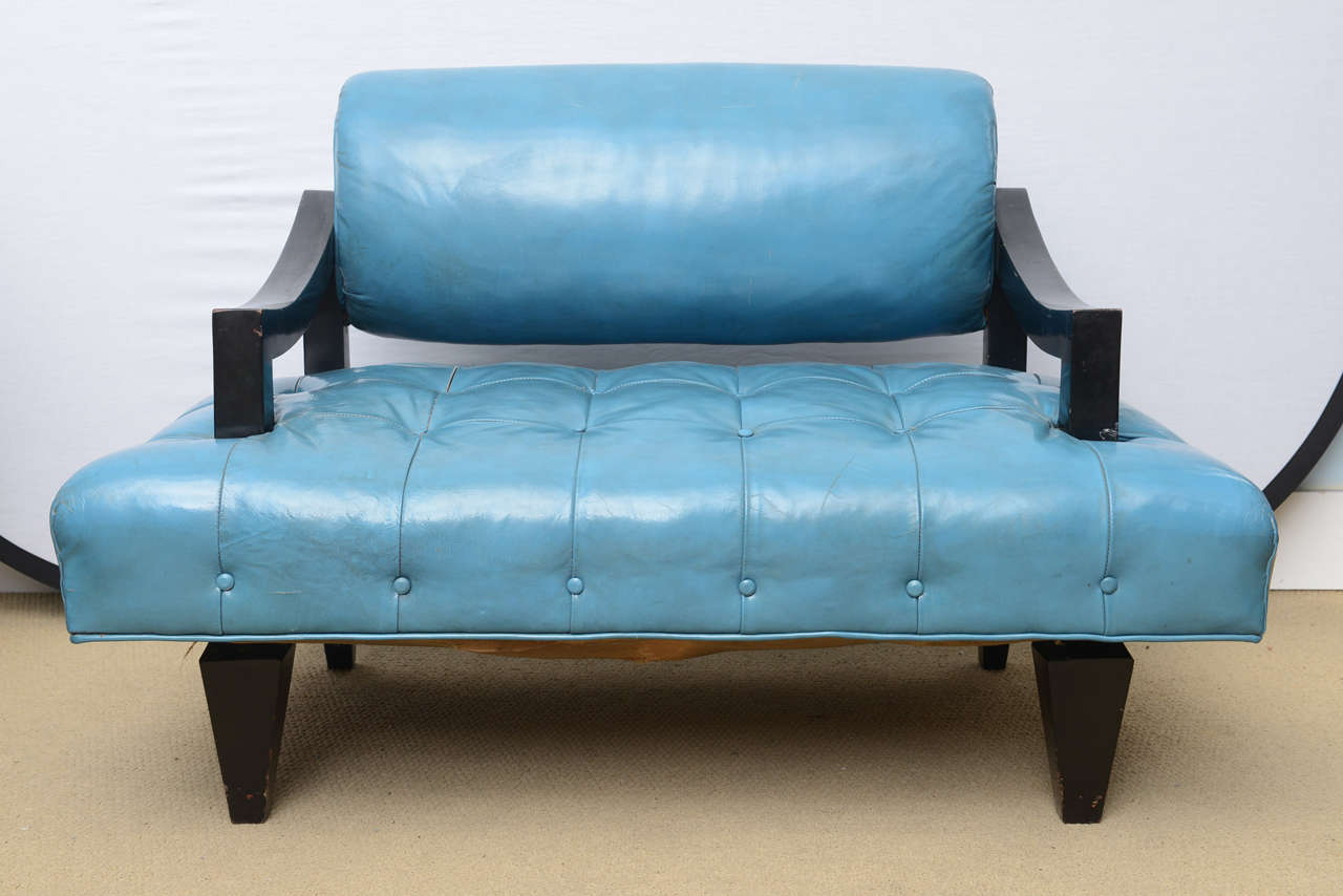 These rare stylized pair of lounge chairs are in all original condition. They retain the original aqua blue or greenish leather, they date back to the 1940s and are in a prefect example of Mr. Mont's Asian and Classic elegance in design. An amazing