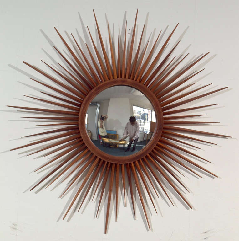 Unique hand made mirror.  Mahogany wood tapered strips attached to a round frame.  12