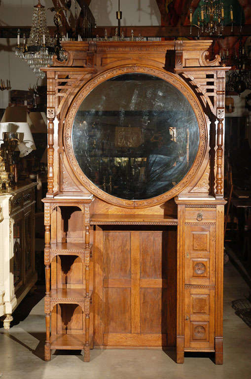 A good example of 19th century Americana. This American barber shop unit, circa 1880, has a large circular mirror, shelves and cupboards. It will indeed make a statement when placed in most settings. 