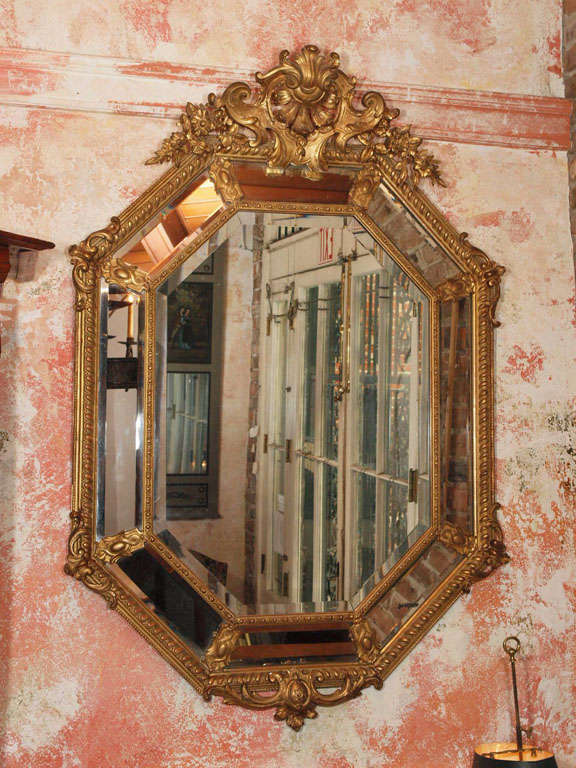 Fine antique French octagonal gold leaf mirror with beveled glass.
