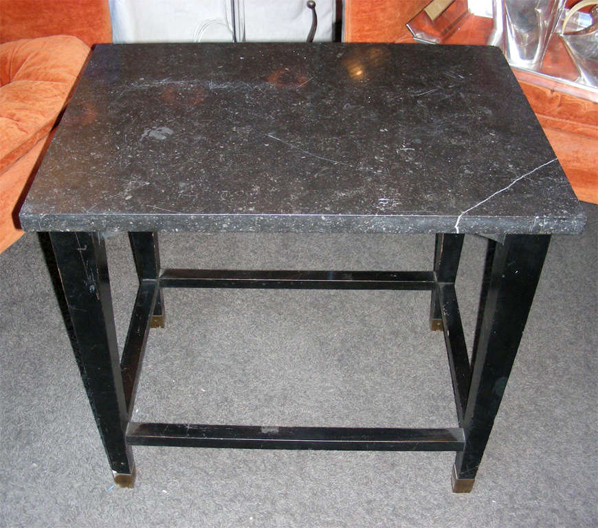 1940s coffee table by Jacques Adnet, with base in black wood and top surface in marble.