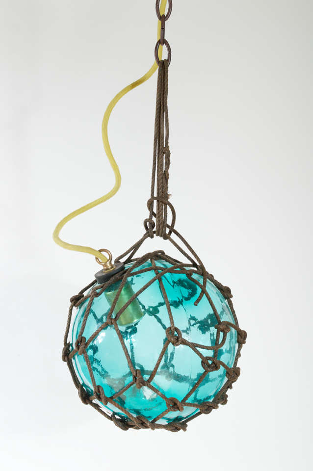 Japanese Fishing Float made into a pendant light. Simple yet unique design, available in different colors (see other postings). This pendant is a pale blue, a light bright aqua glass color. This has been newly wired and are in great condition.