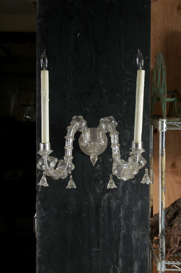 Fanciful pair of 2 arm Murano glass sconces.  Arms entirely encased in reeded glass cups with two bulbous forms and 4 glass tassles, Venice, 19th century.  Tall ivory beeswax candle covers.  There are two pairs of sconces available total.  Sconces