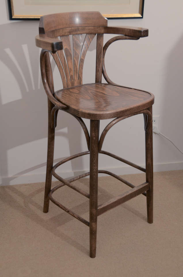 Four barstools from the 1930's from a pub in Turnbridge Wells, England with armrests and footrests. Can be reduced in height 1-6