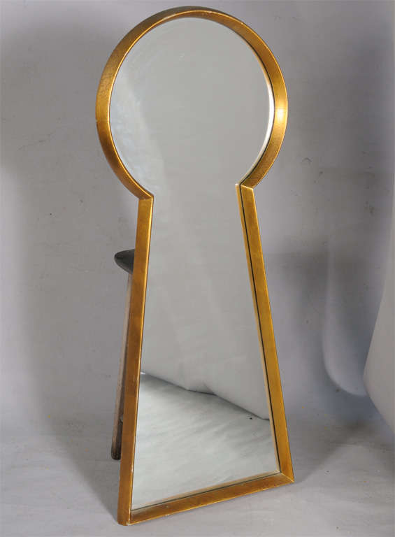 Unusual mirror, having a giltwood frame in the form of a giant keyhole.  From the estate of noted pin-up artist Peter Driben (American, 1903-1968), who often illustrated his subjects inside the silhouette of a keyhole.

Wikipedia page for Driben: