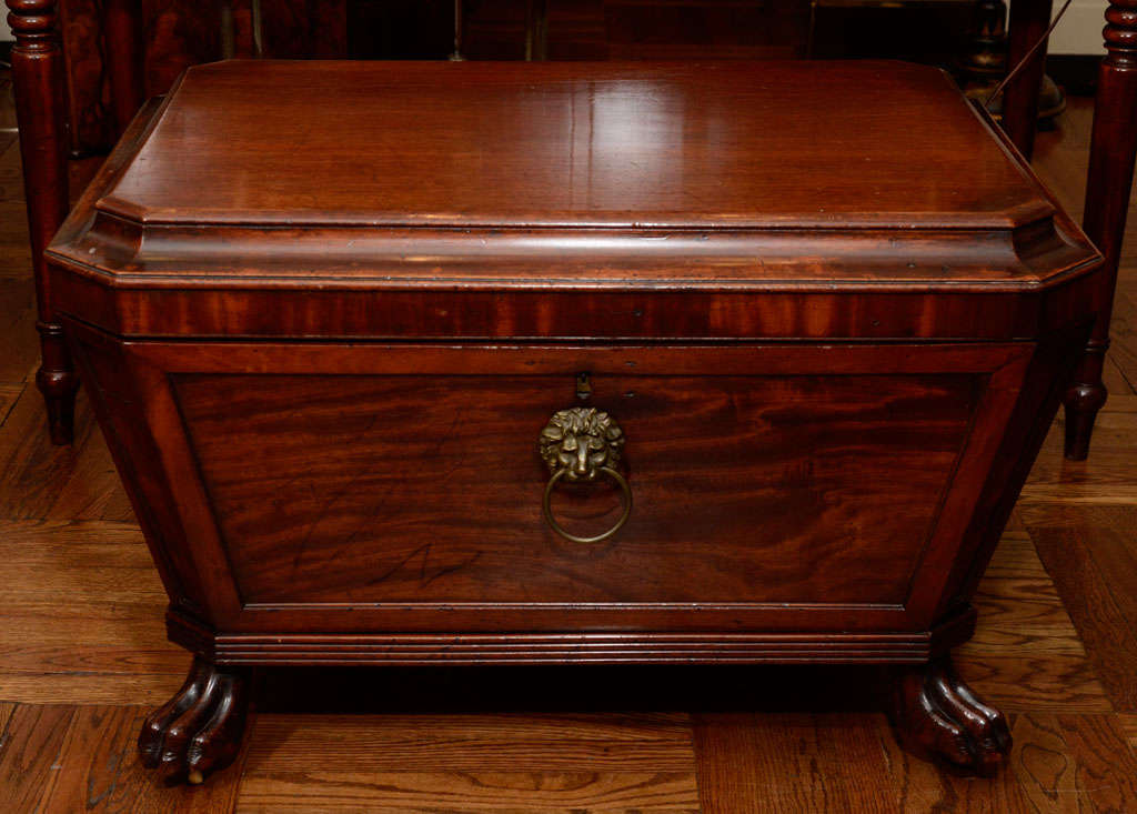 Irish Regency Period Mahogany Cellarette / Wine Cooler with Decorative Brass Pull on Carved Paw Feet; Interior Fitted with Tin Dividers and Drainage Hole.  Ideal as a Coffee Table.  Ireland, c. 1825

34 inches wide x 25 inches deep x 20.5 inches high